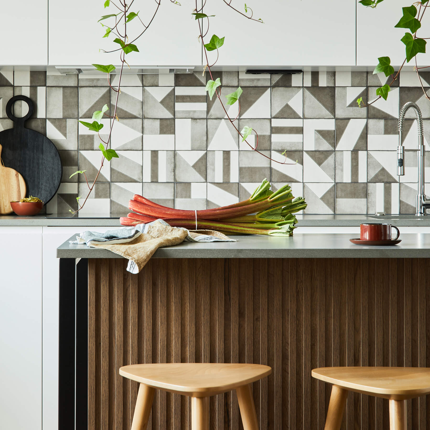 Modern kitchen with geometric tile splashback and timber accents